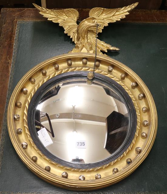 A Regency style giltwood convex wall mirror with eagle and ball, W.2ft 1in.